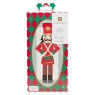 Talking Tables Paper Napkins in a festive nutcracker-themed box. The packaging features a red and green harlequin pattern border with a central illustration of a nutcracker soldier, and a white label on the right side that reads 'Talking Tables PAPER NAPKINS IN PACK' and 'For longer lunches'.