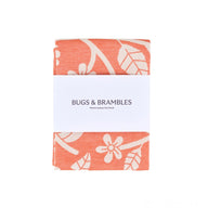 Wrap Tea Towel Bugs and Brambles in orange and white